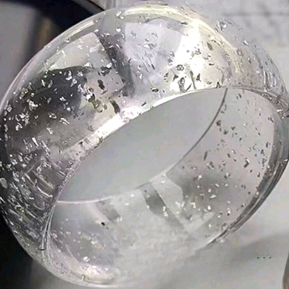 Lucite bangle with silver flecks; nwot
